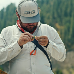 ORIGINAL SHIRT. Man rows in White GameGuard Original Shirt with mesh-lined vents. UPF 50+, quick-dry MicroFiber, wrinkle and stain-resistant, outdoor performance shirt, vented fishing shirt, breathable long sleeve, GameGuard Classic Fit adventure apparel.