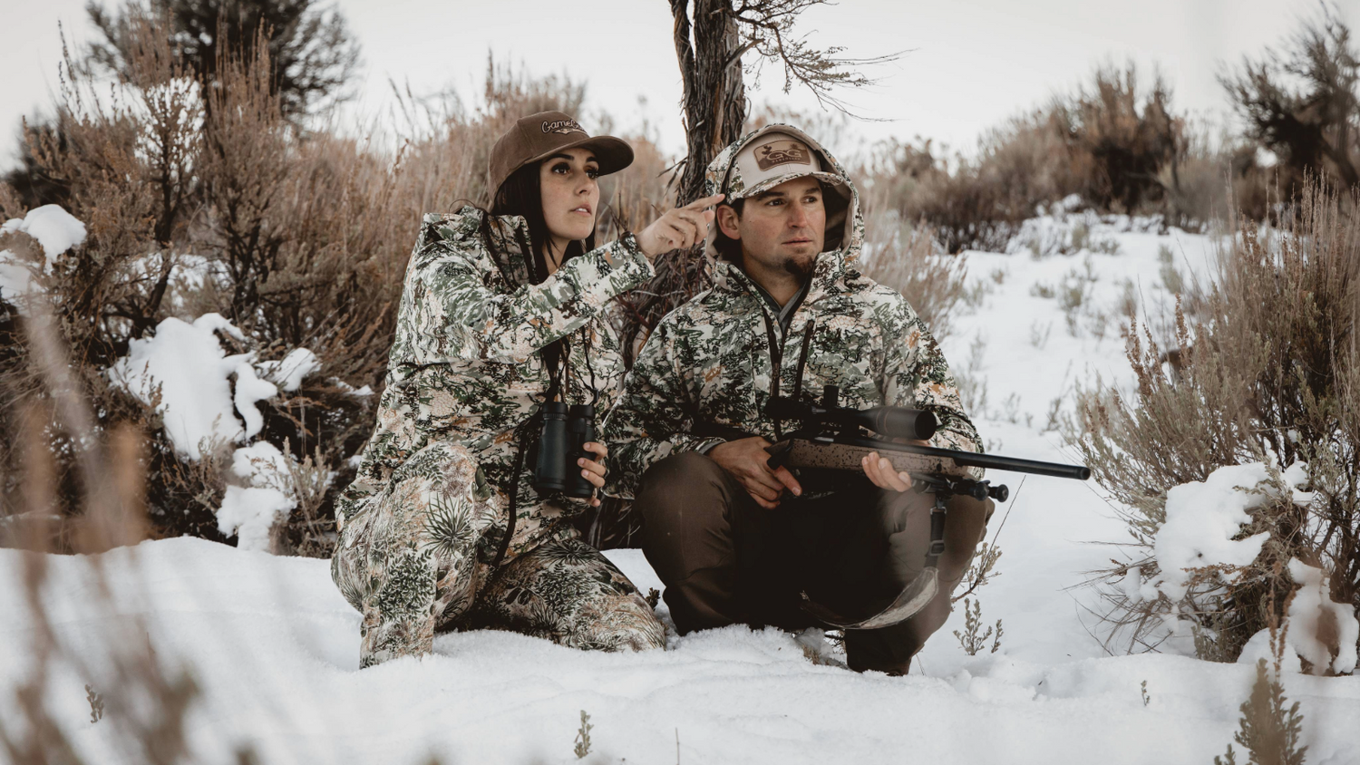 OUTERWEAR. Hunters wear GameGuard Guía Grande Jackets in GameGuard Digital camo while hunting in snow. Waterproof outerwear, windproof hunting jacket, abrasion-resistant, cold-weather camo, rugged field gear, snow-season outerwear, GameGuard Digital camo.