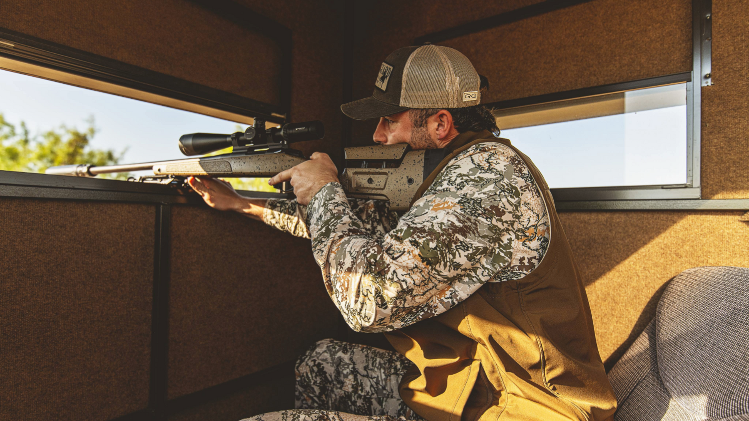 MEN'S HUNTING. Hunter lines up a shot in GameGuard Digital long sleeve shirt, MeshBack Cap, and Guía Grande Vest. Men’s hunting apparel, concealment camo, waterproof hunting vest, moisture-wicking shirt, UPF 50+, durable outdoor gear, GameGuard fieldwear.