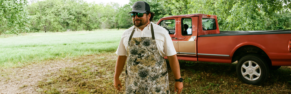 man wearing GameGuard Apron getting ready to cook