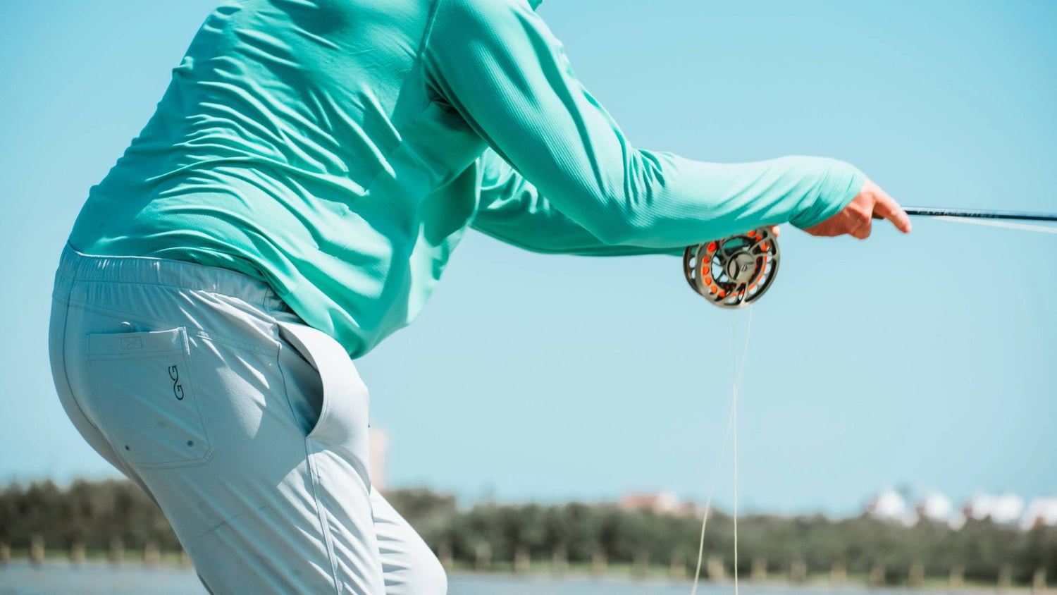 SEADRIFT PANT. Angler casts in GameGuard SeaDrift Pant featuring stretch waistband and lightweight fabric. Performance fishing pant, quick-dry, moisture-wicking, UPF 50+, water-repellent, outdoor pant, GameGuard technical apparel, breathable sun gear.