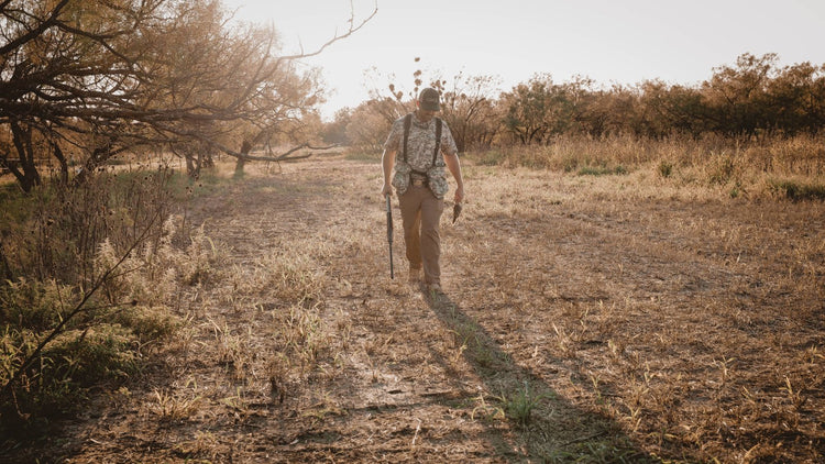 DOVE HUNTING. Hunter wears GameGuard Digital Original Shirt and BirdBelt in Texas field at golden hour. Dove season gear, camo hunting apparel, hunting vest, GameGuard Digital camo, shotgun case, outdoor performance, rugged fieldwear, dove hunt outfit.