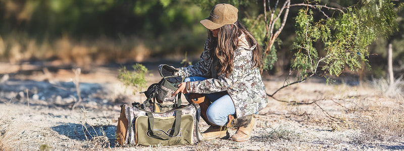 man carrying waterproof duffle bag, the Marine DryDuffle, after fishing on the water. Built for hunting and fishing