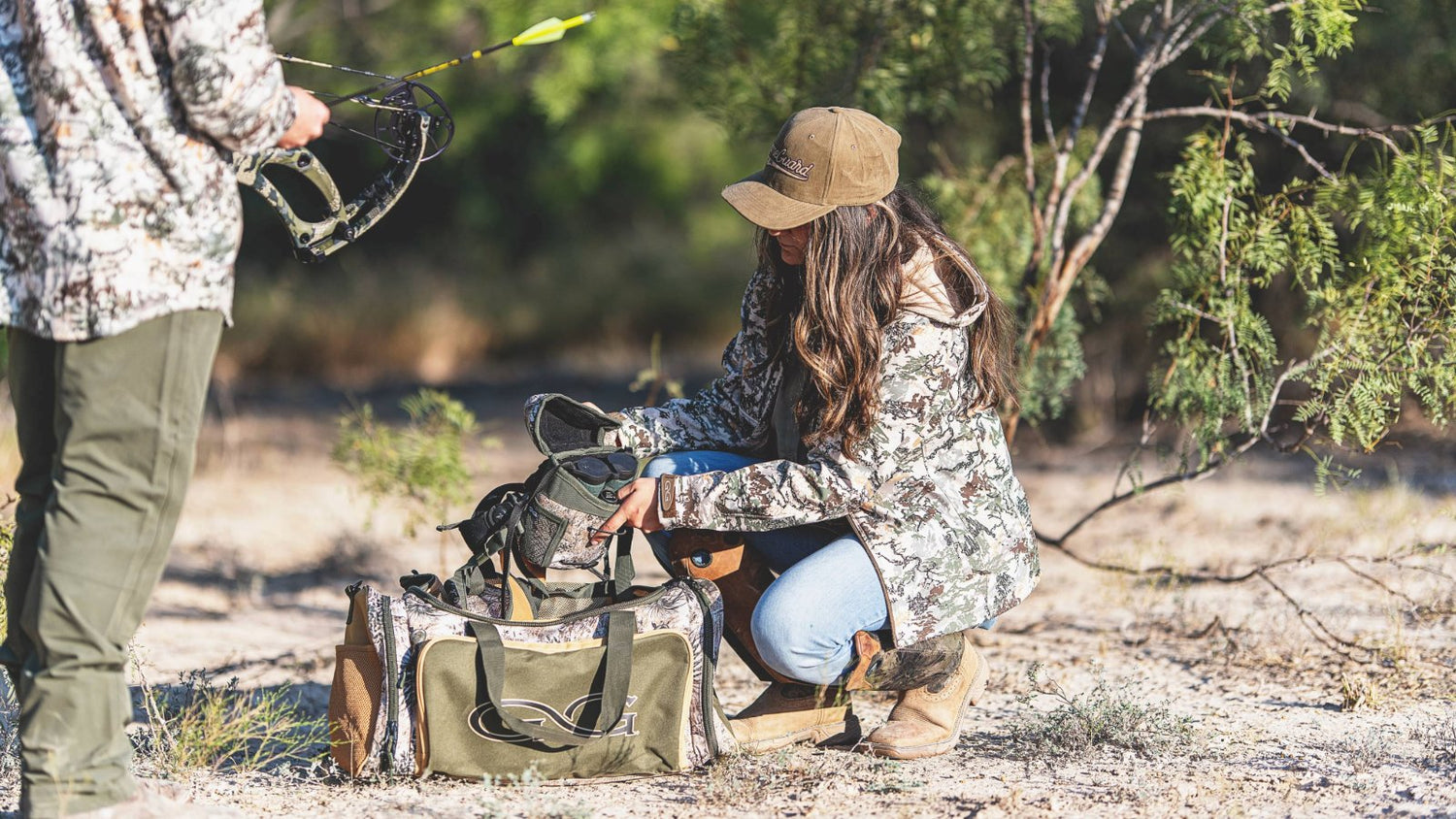 FIELD GEAR. Hunters wear GameGuard Digital camo while packing GameGuard Accessory Bag and Bino Case. Camo field gear, hunting bags, durable outdoor accessories, archery apparel, rugged camo jacket, GameGuard Digital camo duffle, field-tested gear.