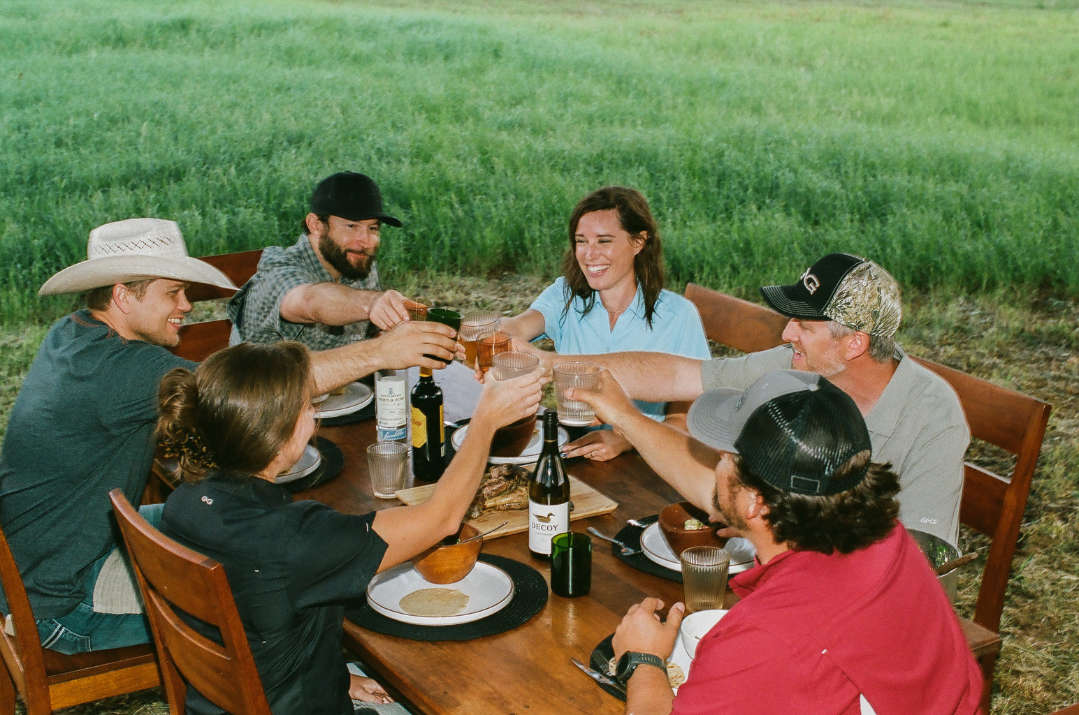 friends sitting around a table outdoors wearing gameguard apparel