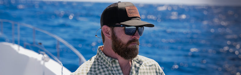 man on water boating on fishing trip wearing GameGuard Cap