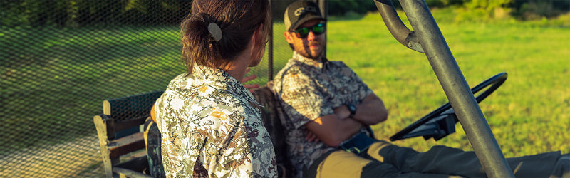 Man and woman outdoors wearing GameGuard Digital Camo shirts