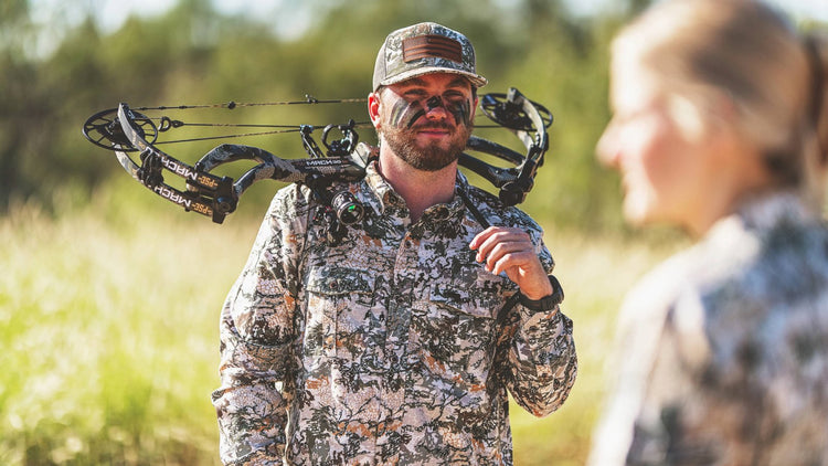 GAMEGUARD DIGITAL CAMO. Bowhunter wears GameGuard Digital Camo shirt and cap. Lightweight hunting shirt, camo apparel, concealment gear, archery shirt, UPF 50+, quick-dry performance, moisture-wicking, field-tested camo, outdoor hunting clothing.