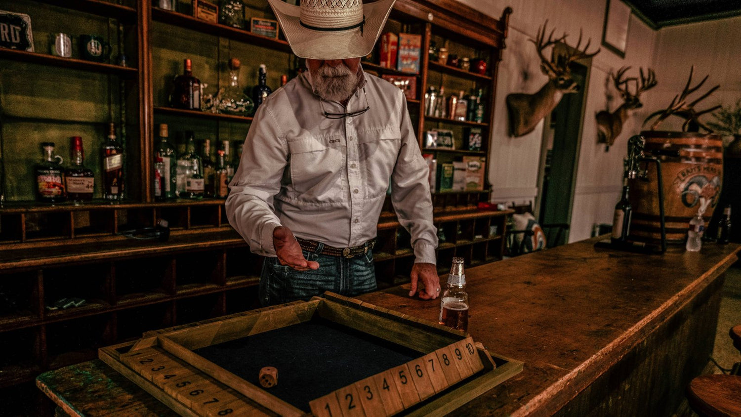 BEST SELLERS. Cowboy in GameGuard Original Shirt plays bar game in rustic saloon. GameGuard best selling outdoor shirt, moisture-wicking, UPF 50+ sun protection, wrinkle-resistant, quick-dry performance shirt, western lifestyle apparel, hunting shirt.