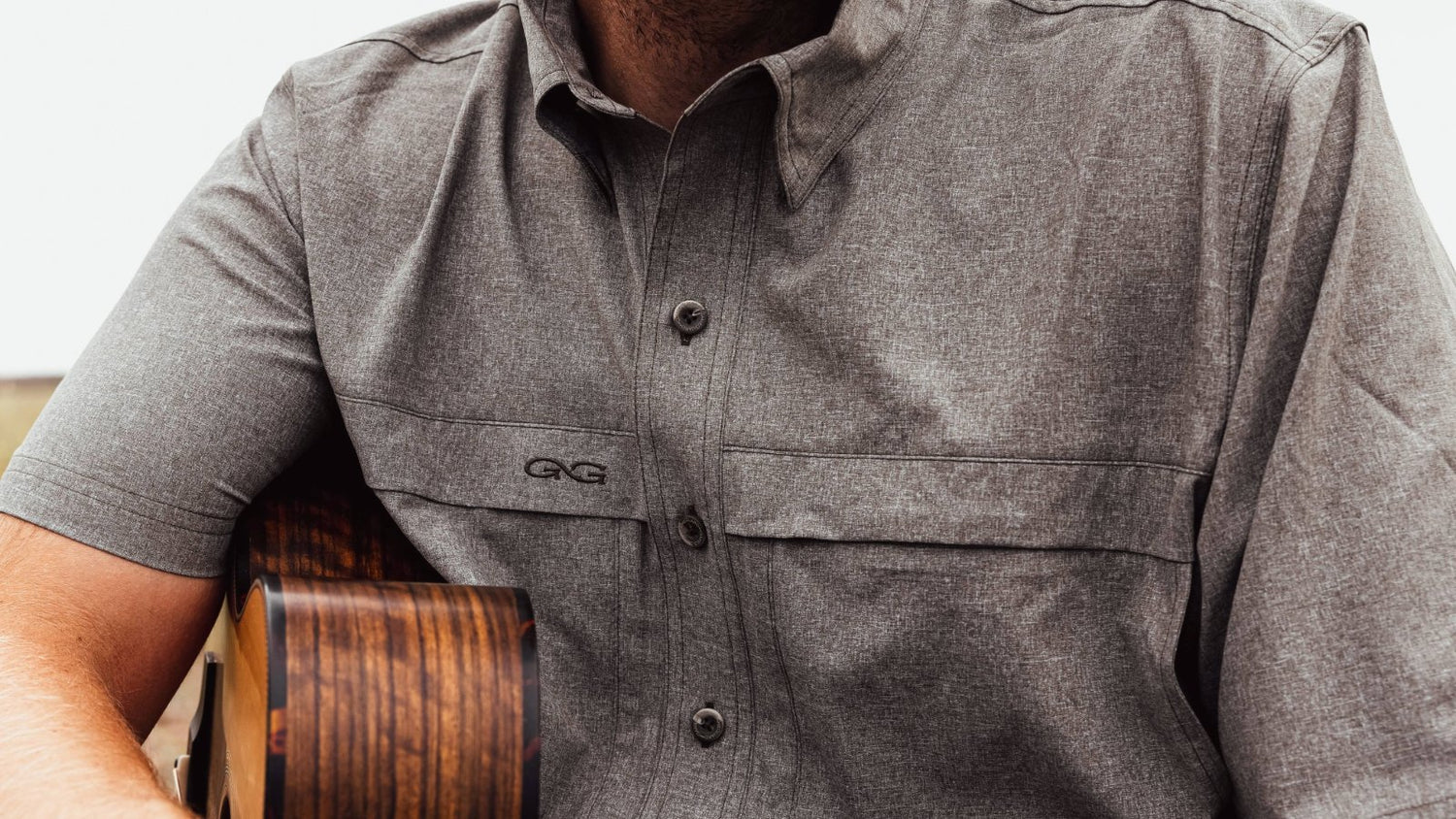 MICROTEK SHIRT. Close-up of GameGuard MicroTek Shirt featuring sleek design and chest pockets. Lightweight MicroFiber, mechanical stretch, UPF 50+, quick-dry, moisture-wicking, stain-resistant, outdoor shirt, GameGuard performance apparel, active fit.