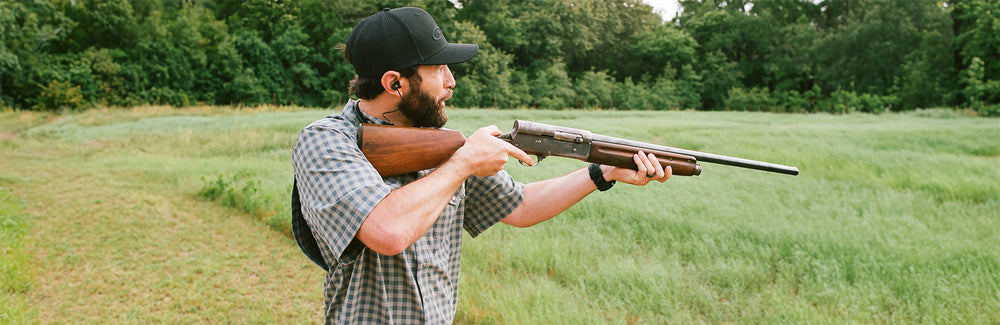 man shooting gun wearing mesuite pearl snap shirt that is short sleeve and lightweight and stretches