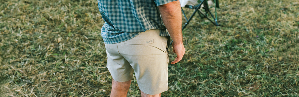 man wearing grey shorts, the Tarpon Travel Shorts, outdoors