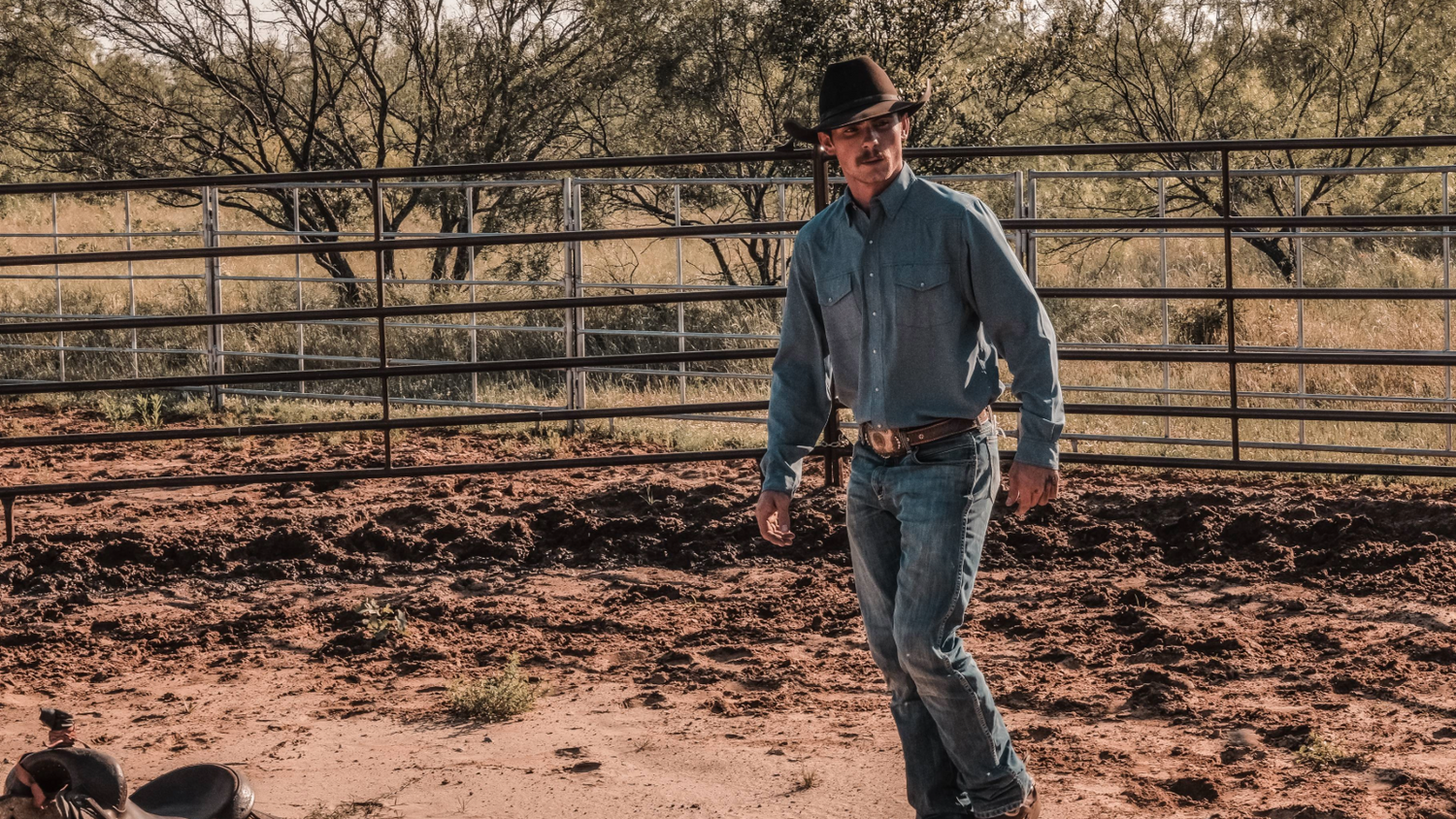 LONG SLEEVE PEARL SNAP. Cowboy in GameGuard Pearl Snap Shirt works hard. Long sleeve western shirt, pearl snap closure, mechanical stretch, UPF 50+, ranch-ready shirt, stain-resistant, moisture-wicking, GameGuard Pearl Snap, classic fit rodeo apparel.