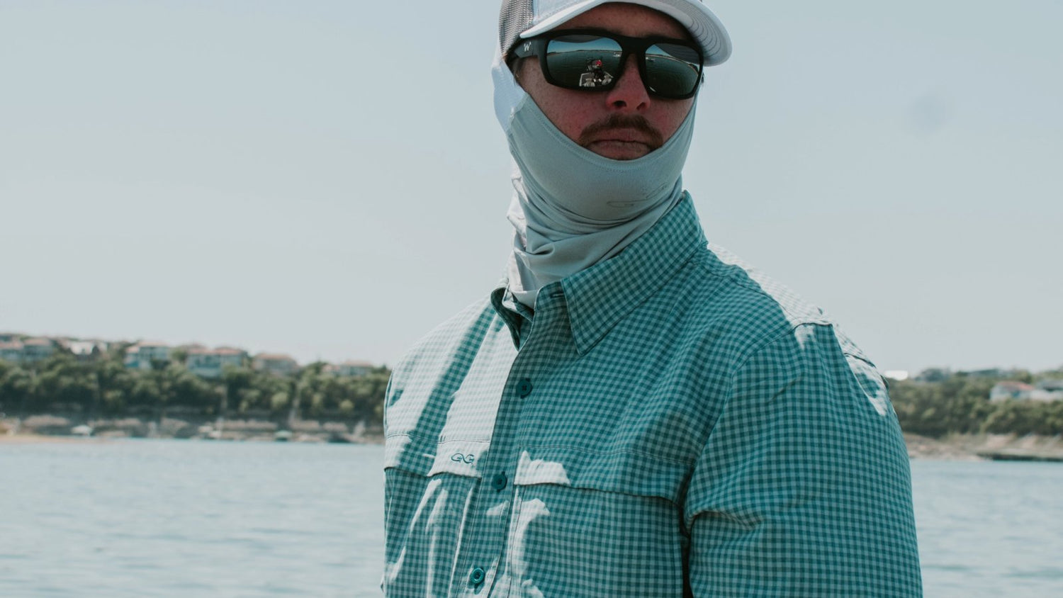 man wearing gameguard sea glass neck gaiter on water