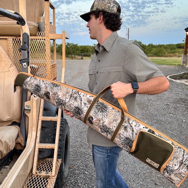 Load image into Gallery viewer, man carrying gameguard shotgun bag loading it into vehicle wearing tekcheck shirt and gameguard cap
