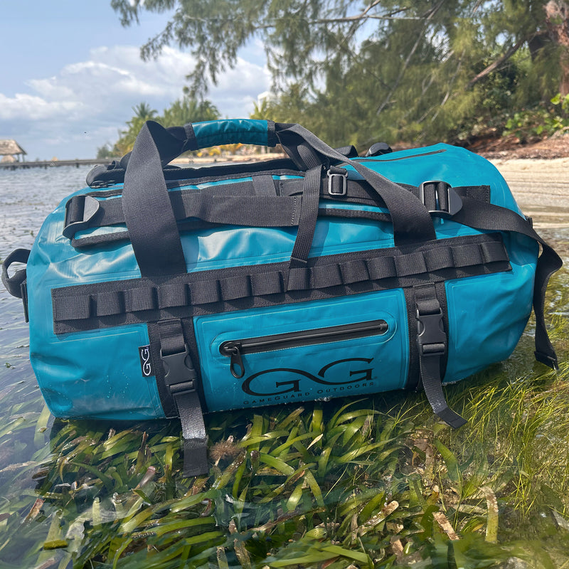 Load image into Gallery viewer, Waterproof dryduffle sitting on ocean water with zippers shut
