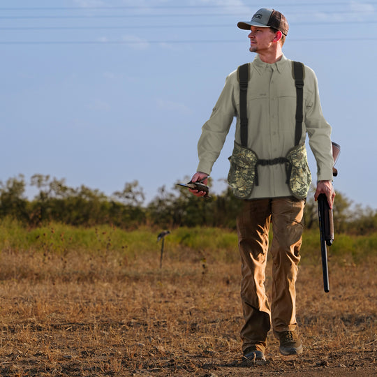 Man wearing GameGuard Digital Field Vest carrying dove and shotgun