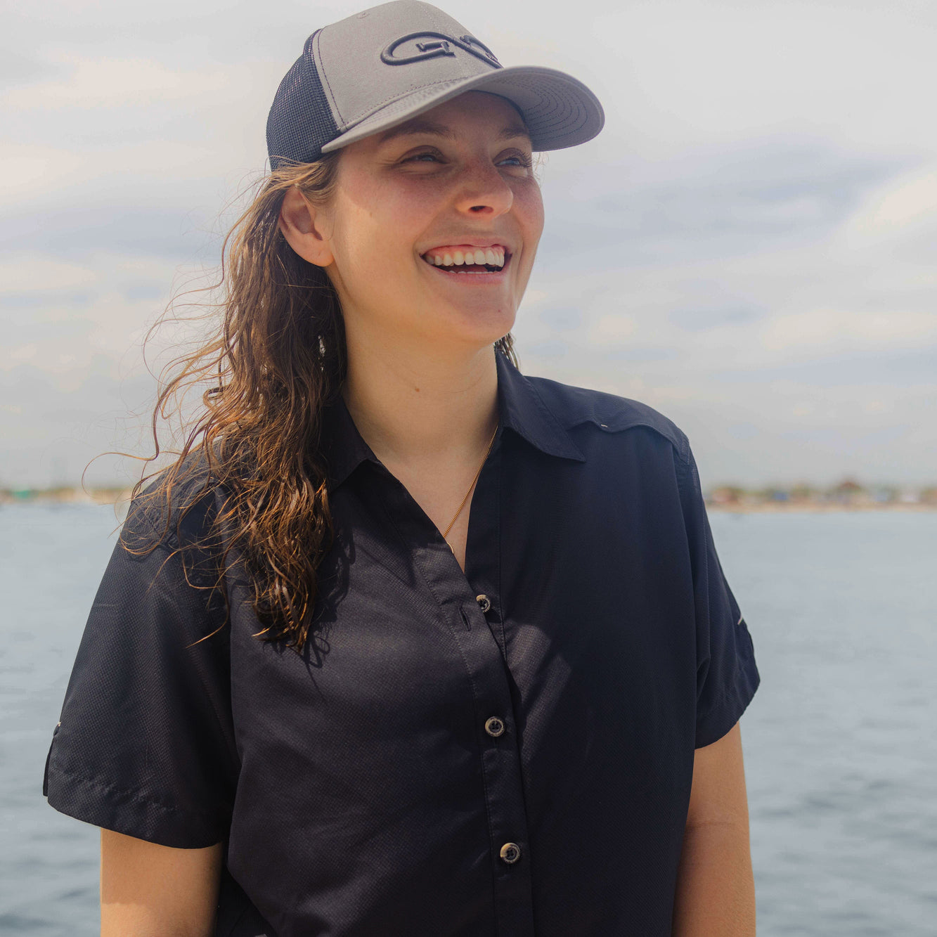 Woman smiling wearing Caviar Ladies' MicroFiber Shirt 