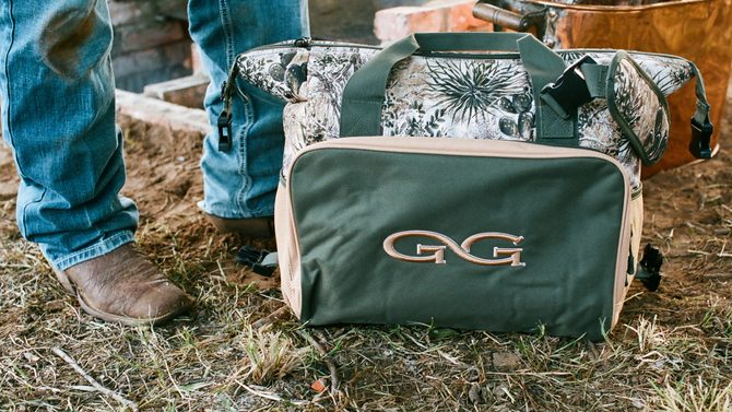 Green and camo cooler bag with 'GG' logo on the ground