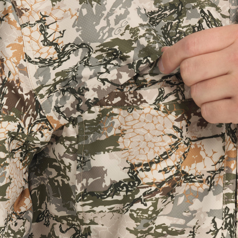 Cargue la imagen en el visor de la galería, Close-up of a hand reaching into the chest pocket of the GameGuard Explorer Shirt (long sleeve), which features a digital camouflage pattern.
