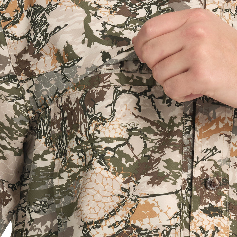 Cargue la imagen en el visor de la galería, Close-up of a hand reaching into the chest pocket of the GameGuard Digital Explorer Shirt, which features a digital camouflage pattern.
