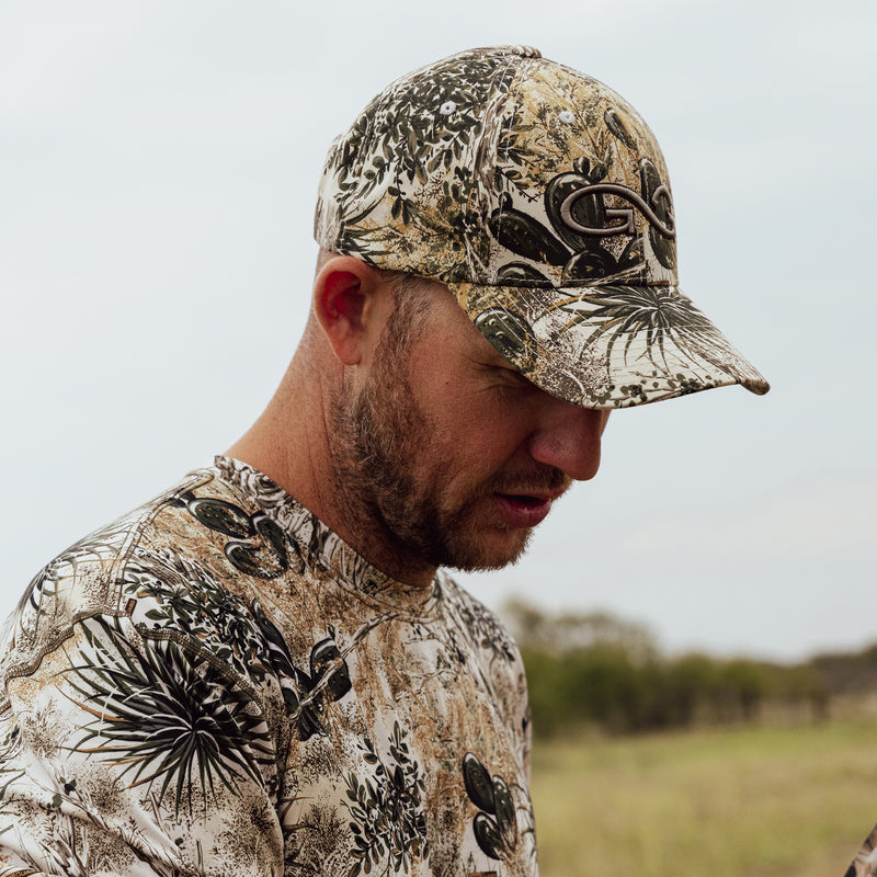 Load image into Gallery viewer, Man wearing GameGuard cap and GameGuard Performance Tee
