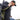 Man walking carrying gun wearing gameguard performance hoody and gameguard fitted cap