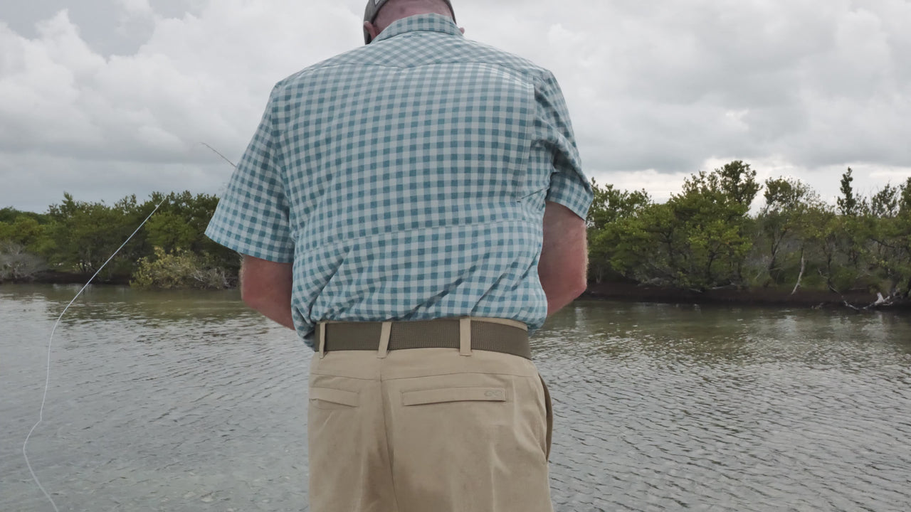 Man getting ready to cast a fishing line staying cool with wind blowing through vents to allow airflow in the GameGuard Pearl Snap Shirt.